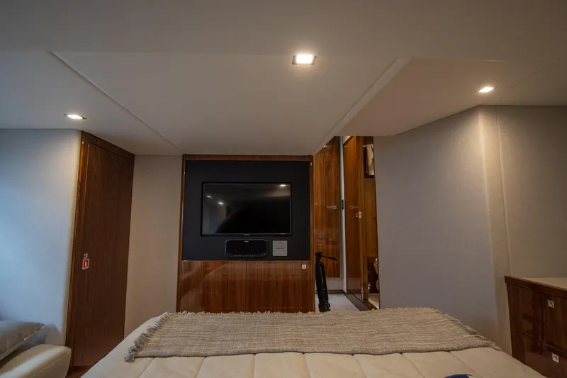  Yacht Photos Pics Luxurious interior of 2024 Riviera 4600 SY yacht with modern TV setup.