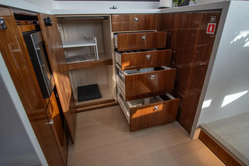  Yacht Photos Pics Luxurious 2024 Riviera 4600 SY yacht interior with wooden cabinetry and ample storage.