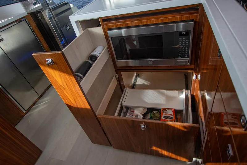  Yacht Photos Pics Modern kitchen in 2024 Riviera 4600 SY yacht with microwave and storage drawers.