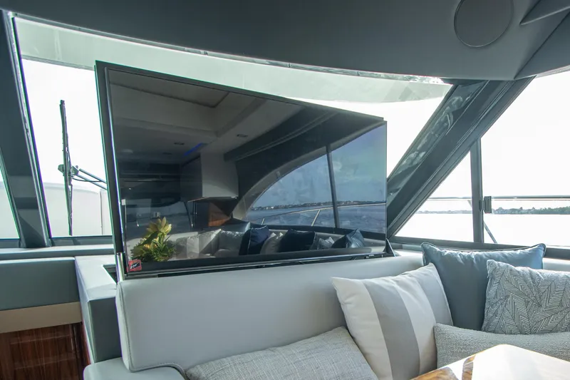  Yacht Photos Pics Luxurious interior of 2024 Riviera 4600 SY yacht with modern TV and plush seating.