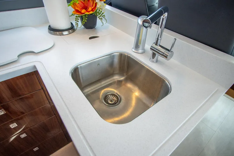  Yacht Photos Pics Modern kitchen sink in 2024 Riviera 4600 SY yacht with sleek faucet and countertop.