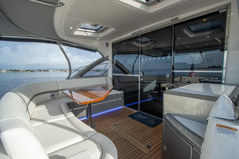  Yacht Photos Pics Luxurious 2024 Riviera 4600 SY yacht interior with sleek seating and modern design.
