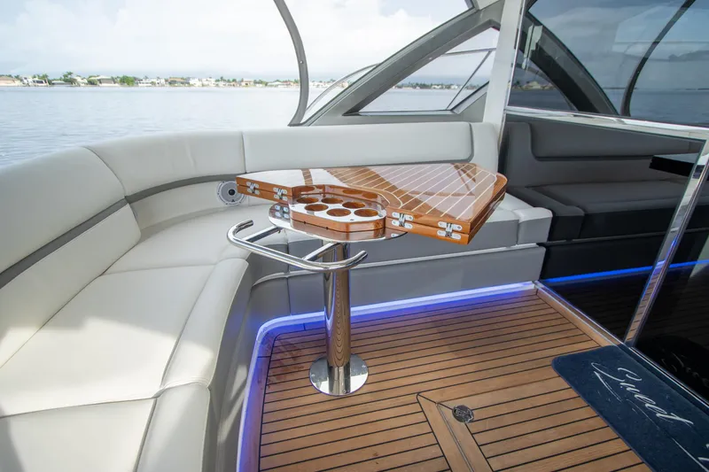  Yacht Photos Pics Luxurious 2024 Riviera 4600 SY yacht interior with elegant seating and wooden table.