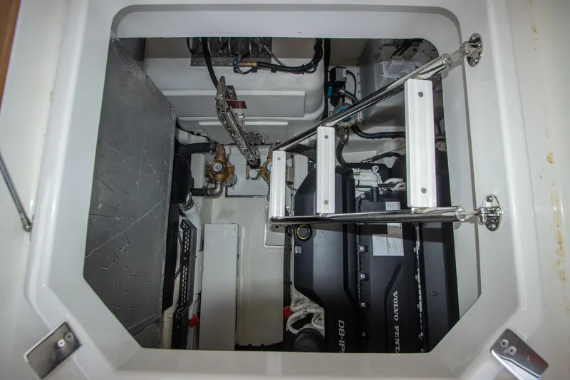  Yacht Photos Pics Engine compartment of 2024 Riviera 4600 SY yacht with visible machinery and ladder.