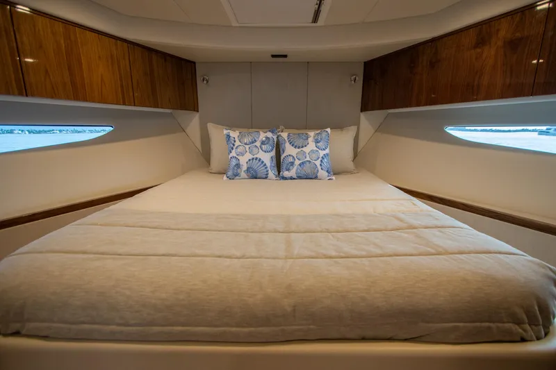  Yacht Photos Pics Luxurious bedroom interior of 2024 Riviera 4600 SY yacht with elegant bedding.