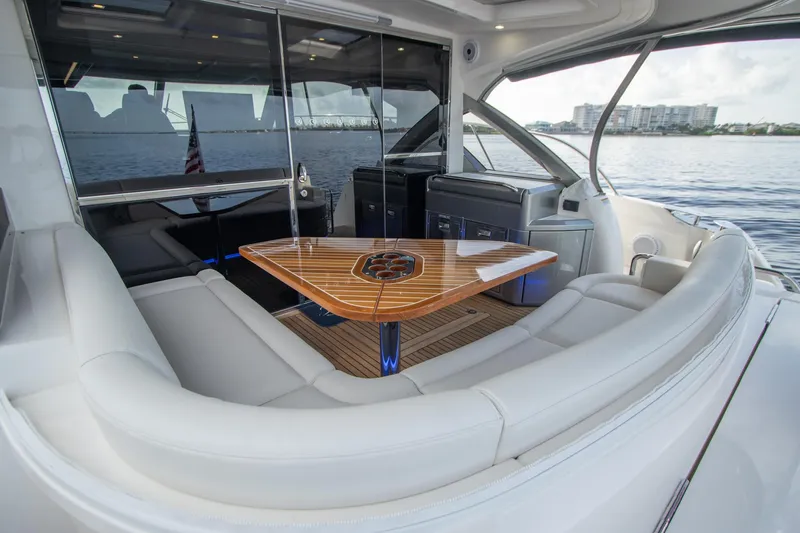  Yacht Photos Pics Luxurious 2024 Riviera 4600 SY yacht interior with elegant seating and wooden table.