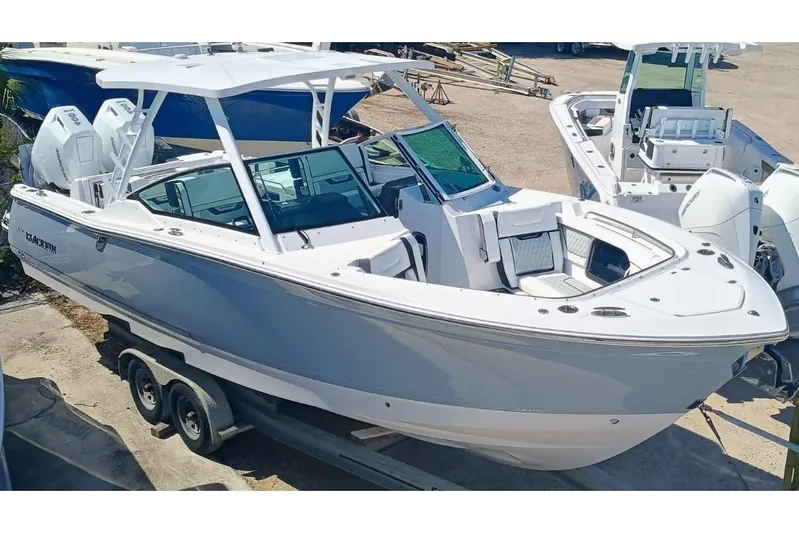 302-126 Yacht Photos Pics 2025 Blackfin 302 DC boat on trailer, featuring sleek design and dual engines.
