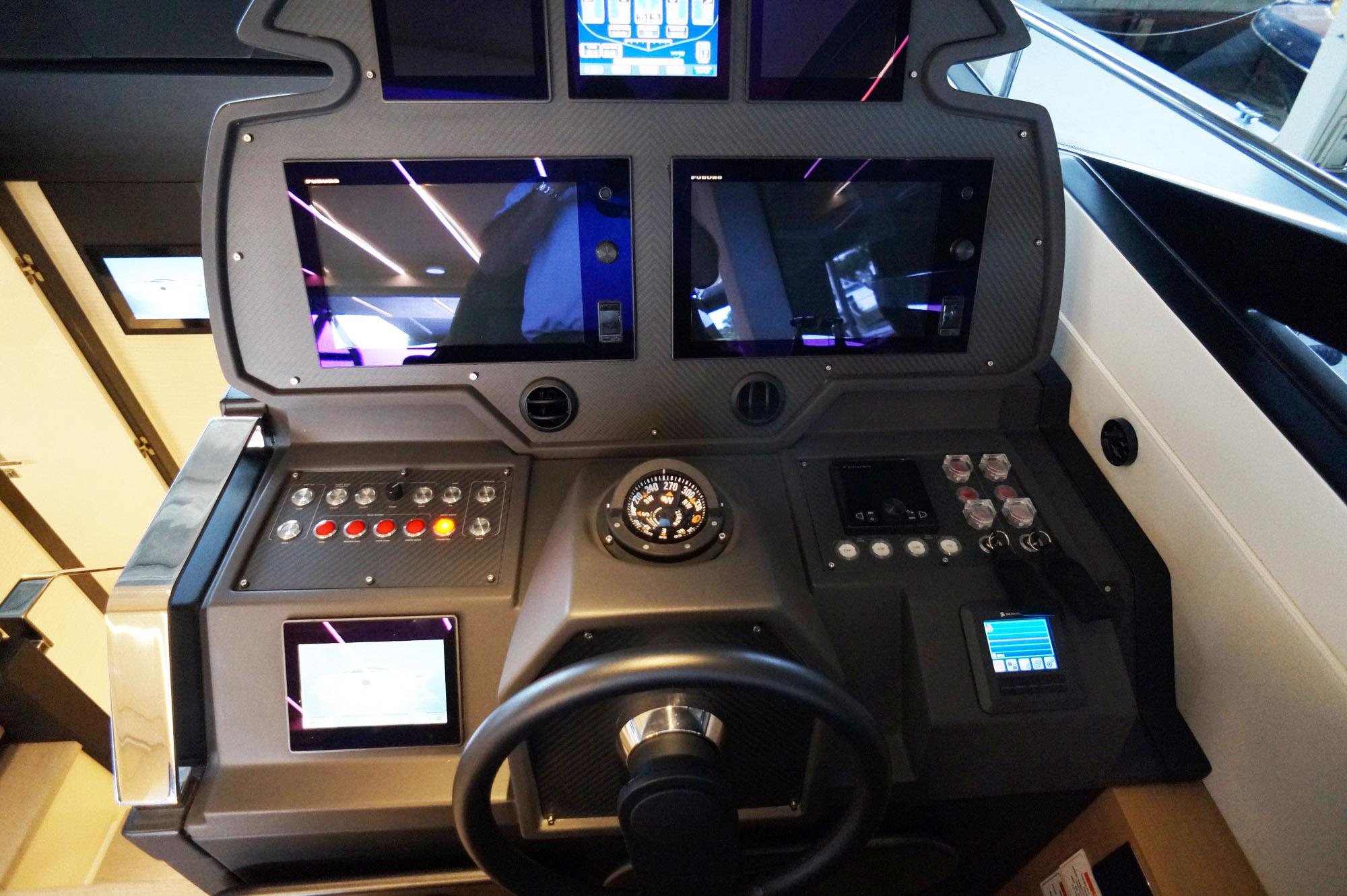 Control panel of a 2016 Pershing 70 yacht with advanced navigation displays.