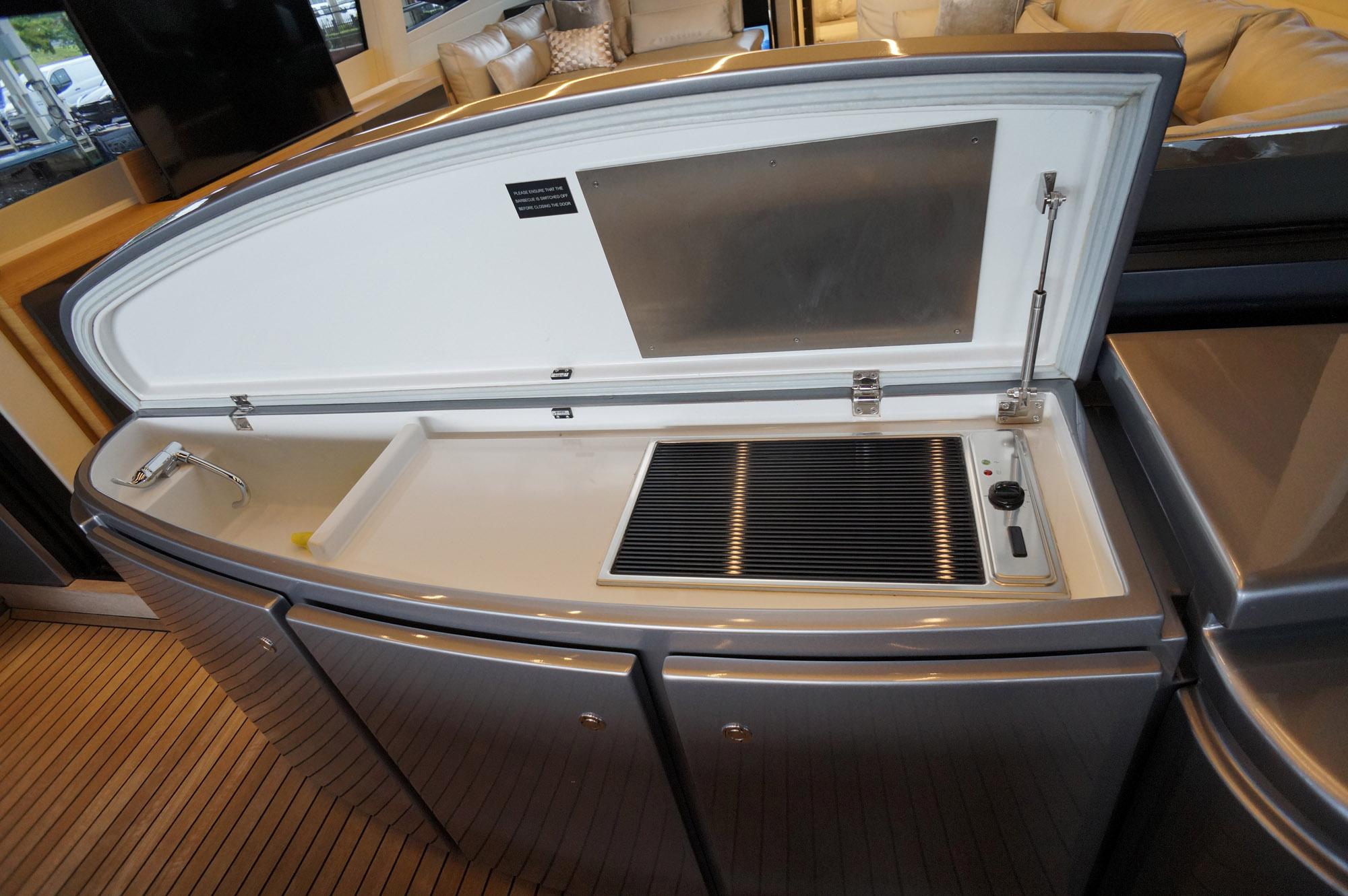 Luxury yacht Pershing 70 (2016) onboard kitchenette with sink and grill.