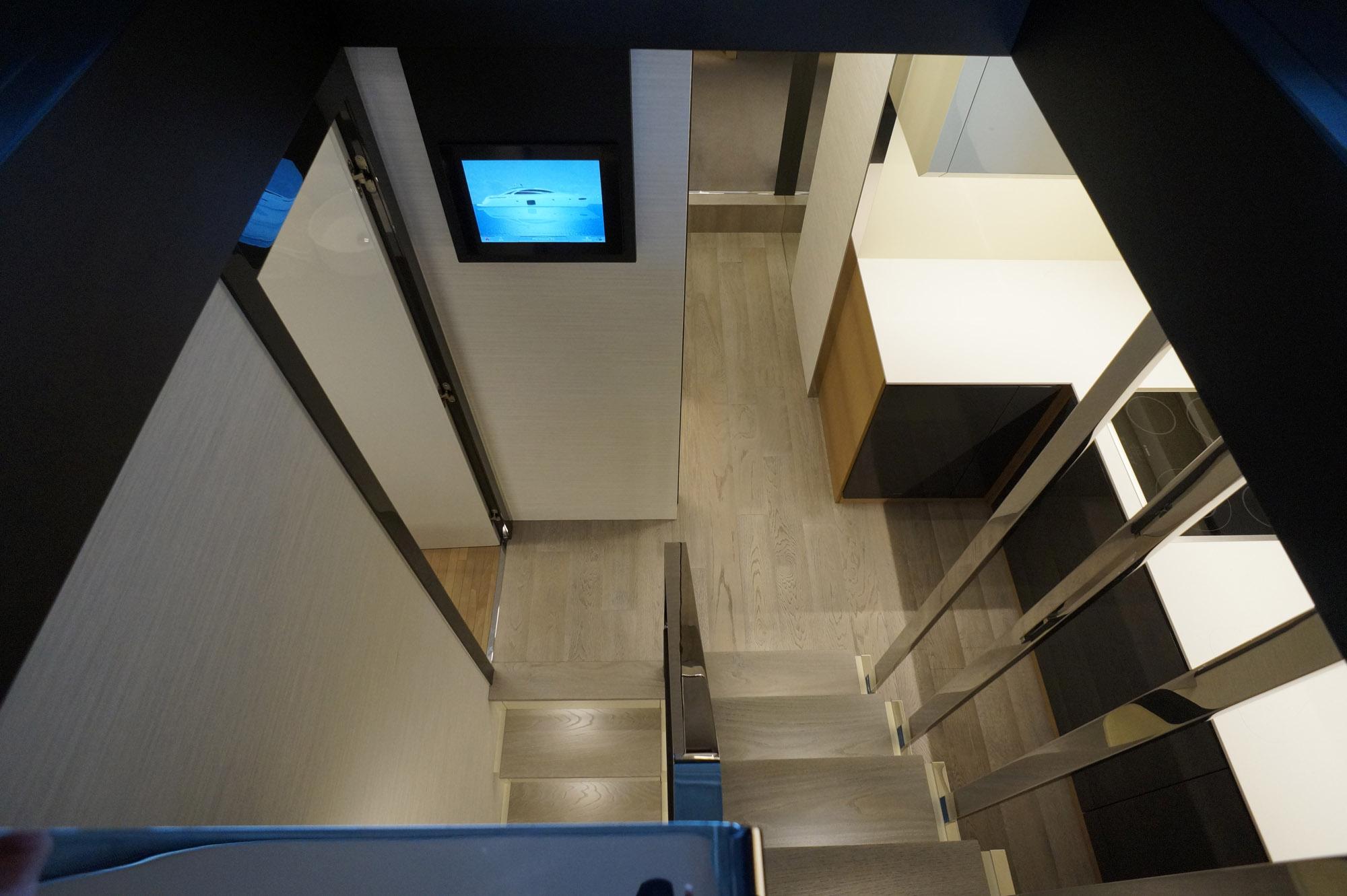 Interior view of 2016 Pershing 70 yacht, featuring modern stairs and sleek design elements.