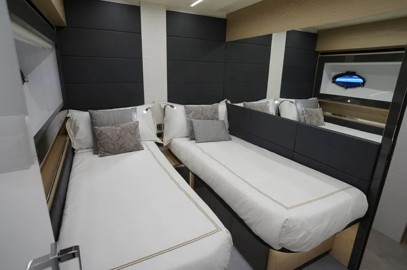 The Office Yacht Photos Pics Luxurious twin bedroom in 2016 Pershing 70 yacht with modern decor and plush bedding.
