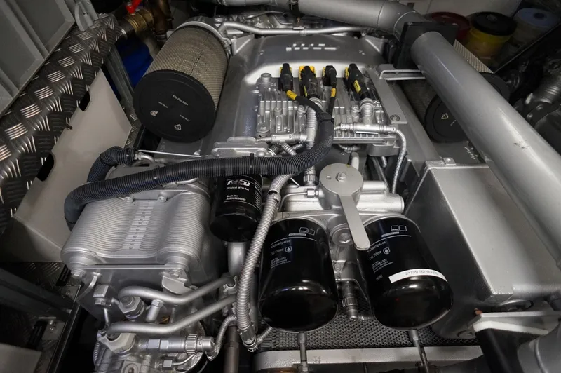 The Office Yacht Photos Pics Engine compartment of a 2016 Pershing 70 yacht, showcasing intricate mechanical components.