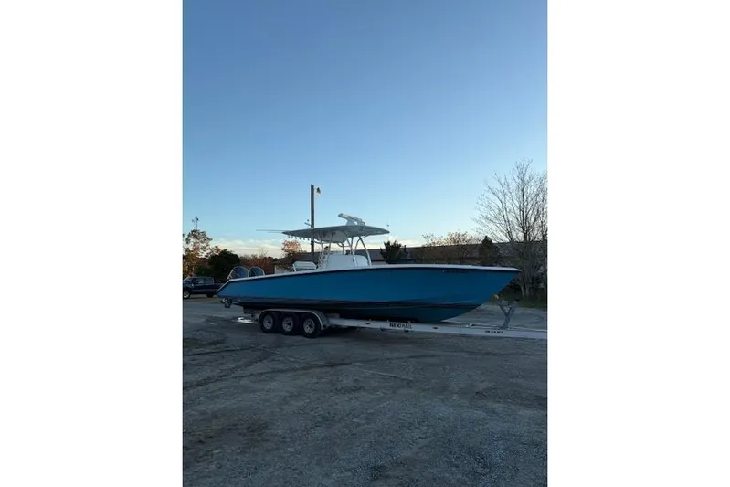  Yacht Photos Pics 2001 Venture 34 Center Console boat on trailer, parked outdoors.