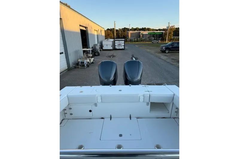  Yacht Photos Pics 2001 Venture 34 Center Console boat with dual engines, parked near industrial buildings.