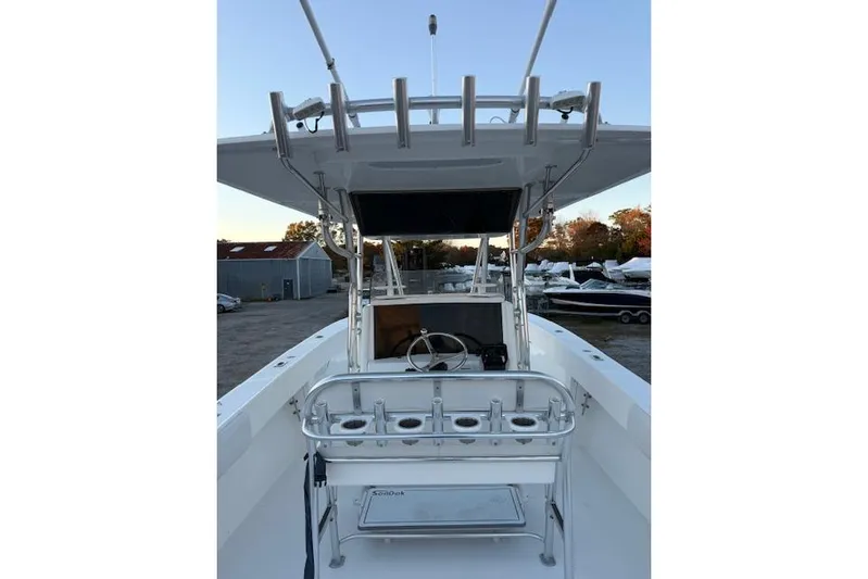 Yacht Photos Pics 2001 Venture 34 Center Console boat with rod holders and steering wheel, docked outdoors.