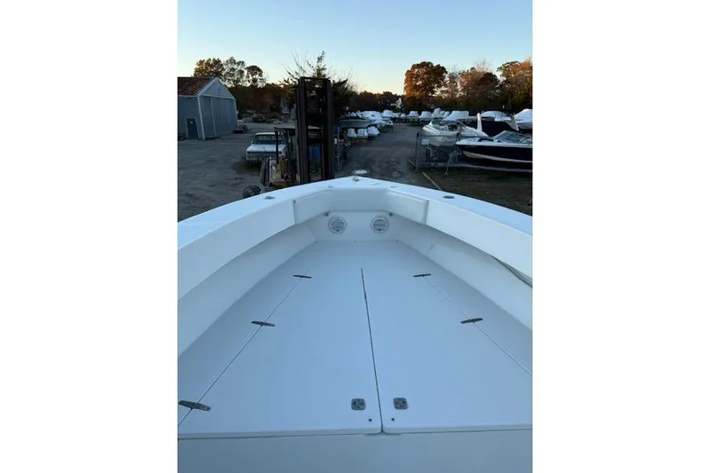  Yacht Photos Pics 2001 Venture 34 Center Console boat docked, surrounded by other boats and trees.