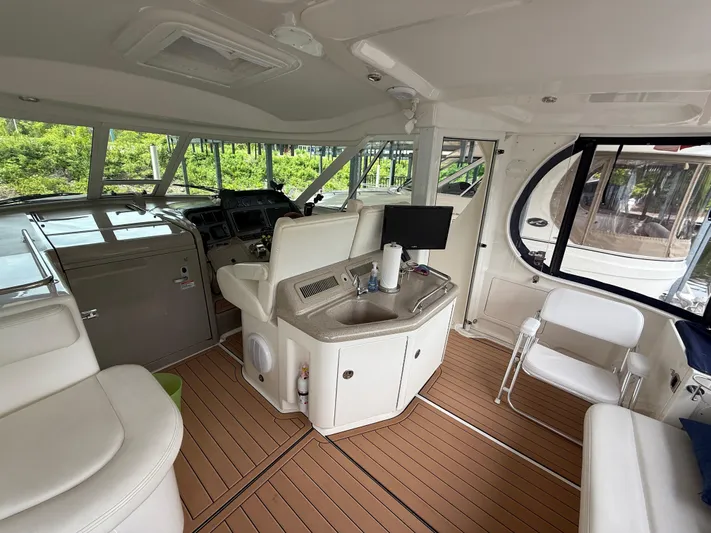 Intermission Yacht Photos Pics Interior of 2005 Sea Ray 390 Motor Yacht with helm, seating, and kitchenette.