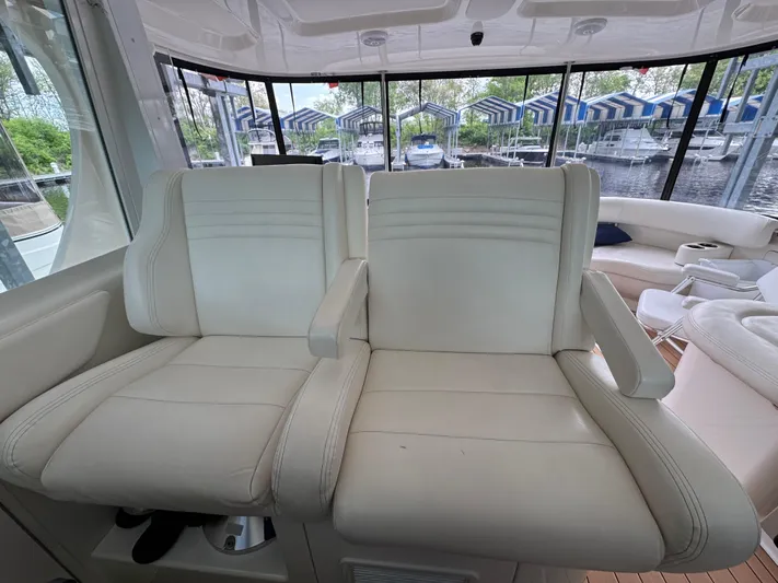 Intermission Yacht Photos Pics 2005 Sea Ray 390 Motor Yacht interior with white leather seating and marina view.