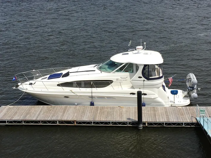 Intermission Yacht Photos Pics 2005 Sea Ray 390 Motor Yacht docked on calm water.