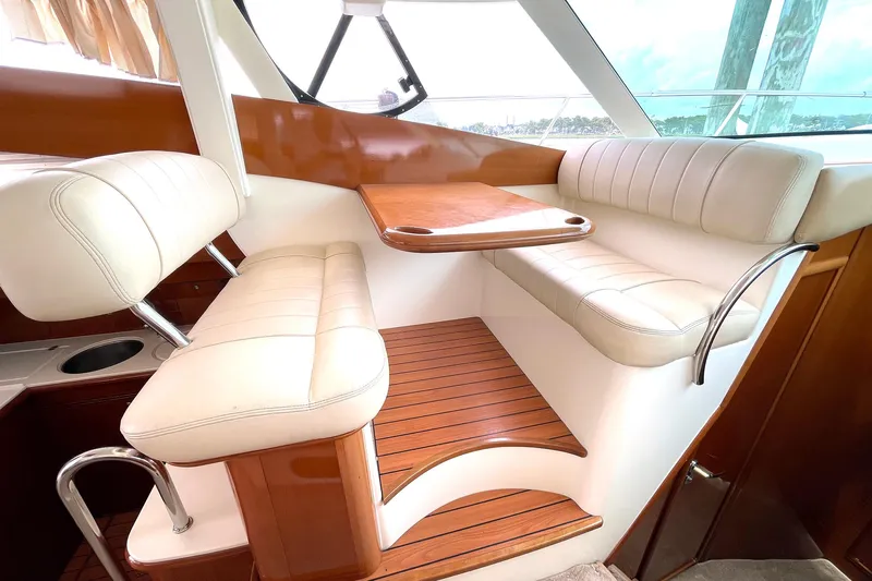 Our Three Buoys Yacht Photos Pics Luxurious interior seating area of 2007 Jeanneau Prestige 46 yacht with wooden accents.