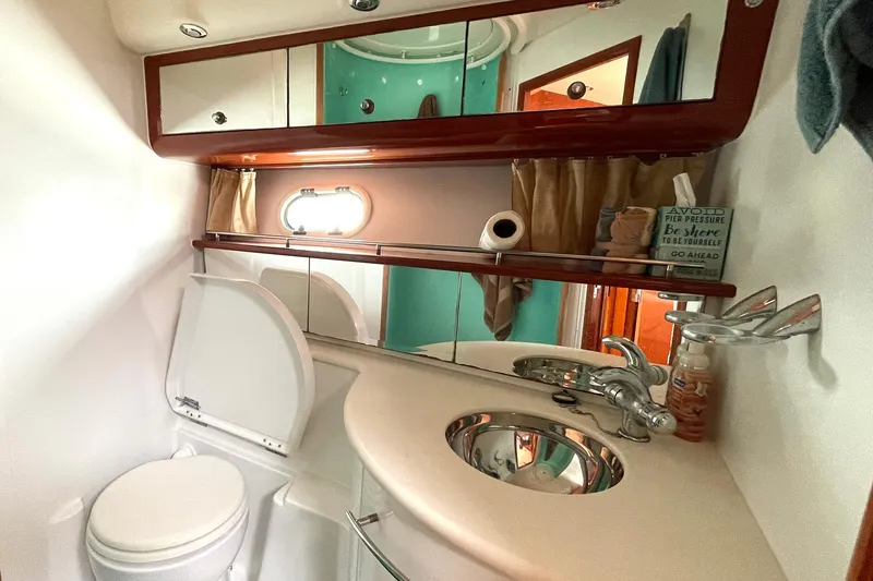 Our Three Buoys Yacht Photos Pics Bathroom interior of 2007 Jeanneau Prestige 46 yacht with sink, mirror, and toilet.