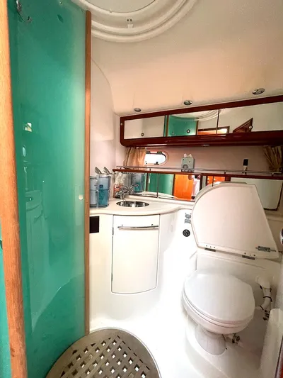 Our Three Buoys Yacht Photos Pics Luxurious bathroom in 2007 Jeanneau Prestige 46 yacht with modern fixtures and teal accents.