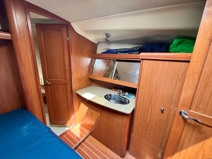 Mariah Yacht Photos Pics Interior of 2008 Hunter 41 Deck Salon with wood cabinetry and compact sink.