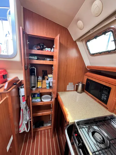 Mariah Yacht Photos Pics 2008 Hunter 41 Deck Salon kitchen with wooden cabinets and modern appliances.