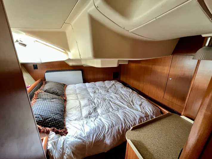 Mariah Yacht Photos Pics Interior cabin of 2008 Hunter 41 Deck Salon with cozy bed and wooden furnishings.