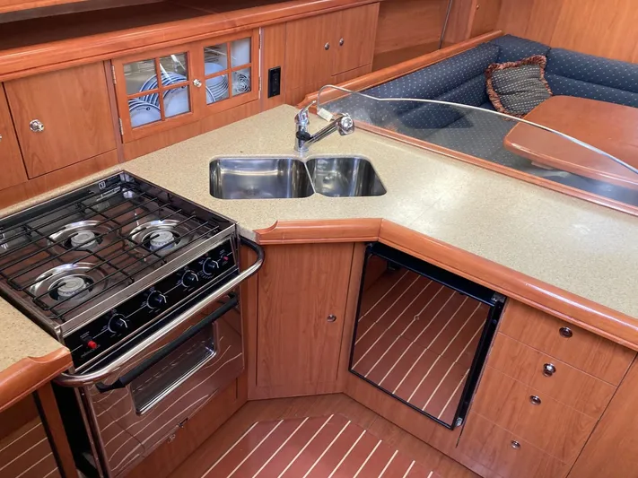 Mariah Yacht Photos Pics 2008 Hunter 41 Deck Salon kitchen with stove, sink, and wood cabinetry.