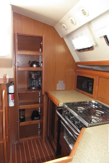 Mariah Yacht Photos Pics 2008 Hunter 41 Deck Salon kitchen with stove, cabinets, and appliances.