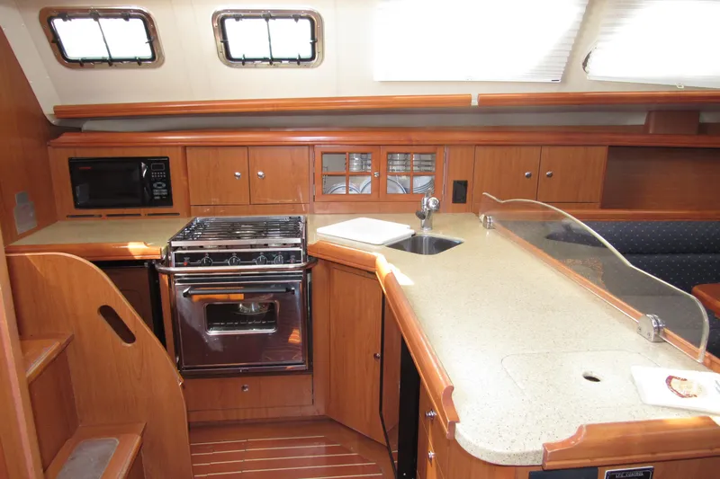Mariah Yacht Photos Pics 2008 Hunter 41 Deck Salon kitchen with wood cabinetry, stove, and microwave.