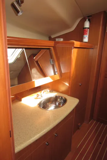 Mariah Yacht Photos Pics 2008 Hunter 41 Deck Salon bathroom with wooden cabinetry and stainless steel sink.