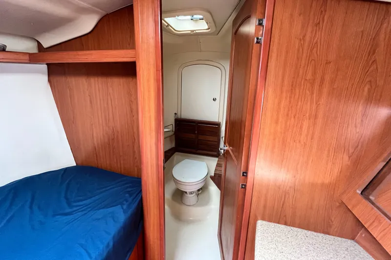 Mariah Yacht Photos Pics 2008 Hunter 41 Deck Salon interior with wood finish, bed, and bathroom.