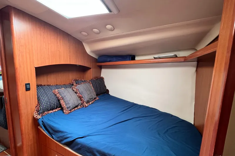 Mariah Yacht Photos Pics Cozy cabin interior of 2008 Hunter 41 Deck Salon with blue bedding and wooden accents.