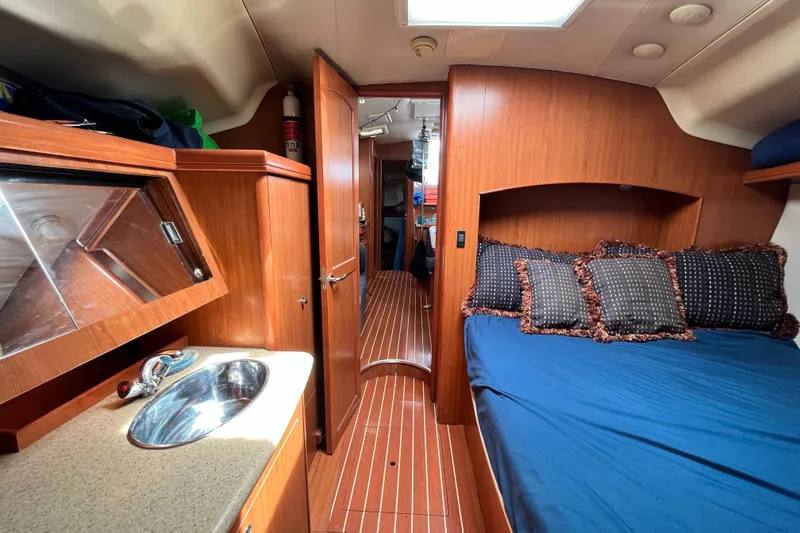 Mariah Yacht Photos Pics Interior of 2008 Hunter 41 Deck Salon with wood finish and cozy bedding.
