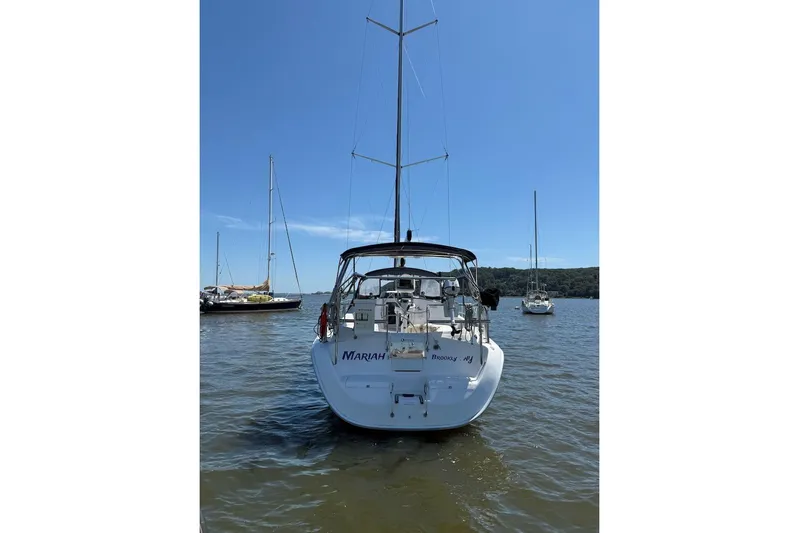 Mariah Yacht Photos Pics 2008 Hunter 41 Deck Salon sailboat on calm water, clear blue sky background.