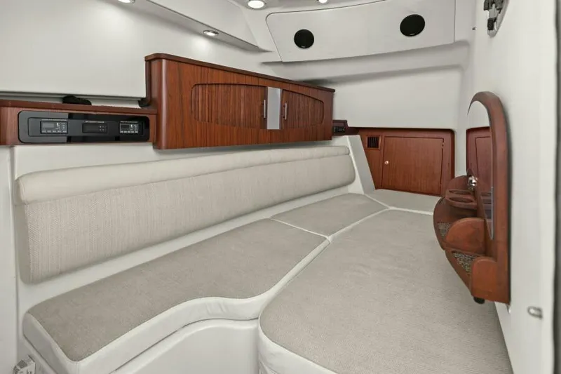  Yacht Photos Pics 2016 Grady-White Freedom 375 cabin interior with cushioned seating and wooden cabinetry.
