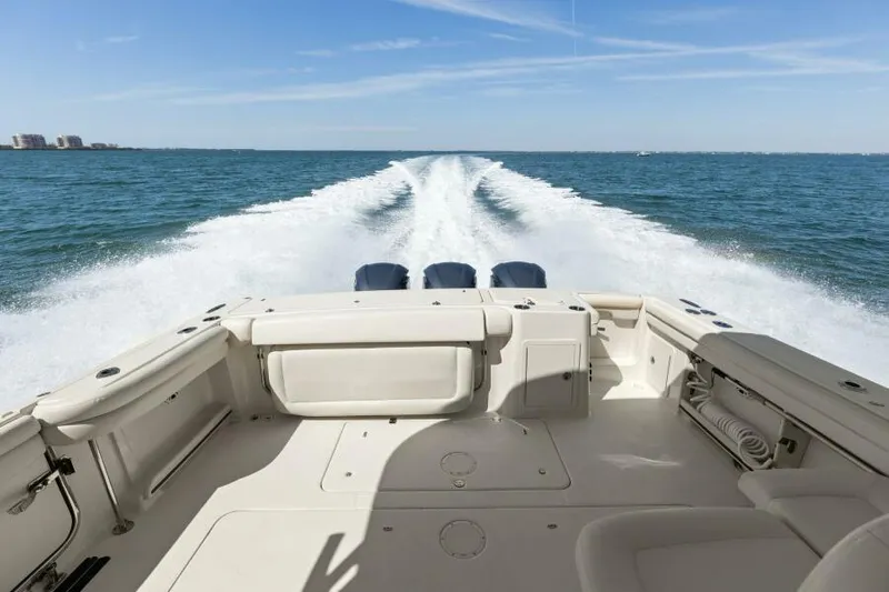  Yacht Photos Pics 2016 Grady-White Freedom 375 boat cruising on open water, leaving a wake behind.