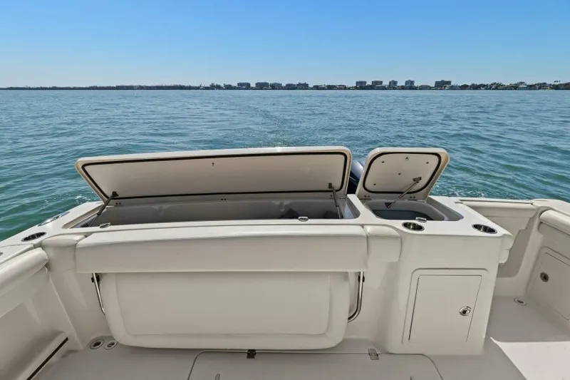  Yacht Photos Pics 2016 Grady-White Freedom 375 boat with open storage compartments on calm water.