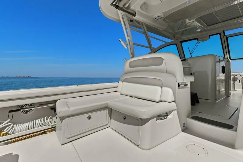  Yacht Photos Pics 2016 Grady-White Freedom 375 boat interior with seating, ocean view, and clear blue sky.