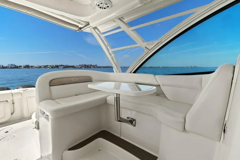  Yacht Photos Pics 2016 Grady-White Freedom 375 boat interior with white seating and table, overlooking calm blue waters.