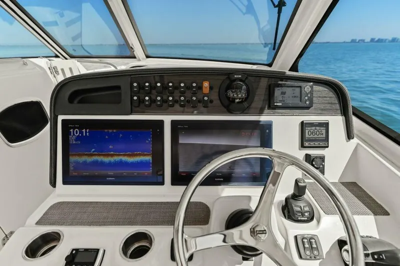  Yacht Photos Pics 2016 Grady-White Freedom 375 helm with advanced navigation displays and controls, overlooking the ocean.