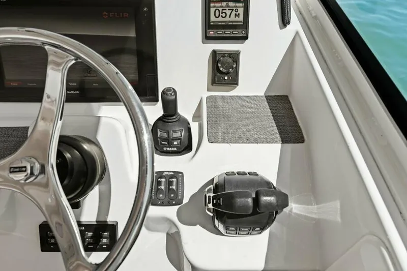  Yacht Photos Pics Control panel of 2016 Grady-White Freedom 375 boat with steering wheel and navigation instruments.