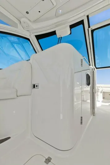  Yacht Photos Pics 2016 Grady-White Freedom 375 boat interior with sleek white design and blue-tinted windows.