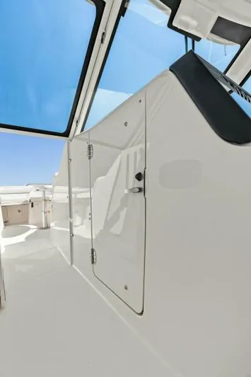  Yacht Photos Pics 2016 Grady-White Freedom 375 boat interior with sleek white design and clear blue sky.