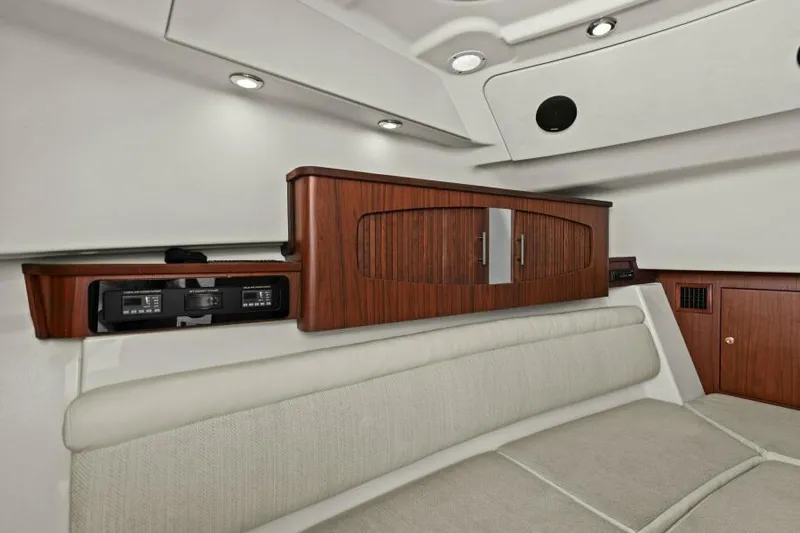  Yacht Photos Pics 2016 Grady-White Freedom 375 cabin interior with wood cabinetry and cushioned seating.