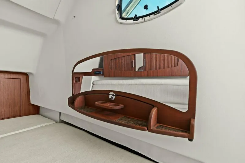  Yacht Photos Pics Interior cabin of 2016 Grady-White Freedom 375 boat with wooden accents and window.