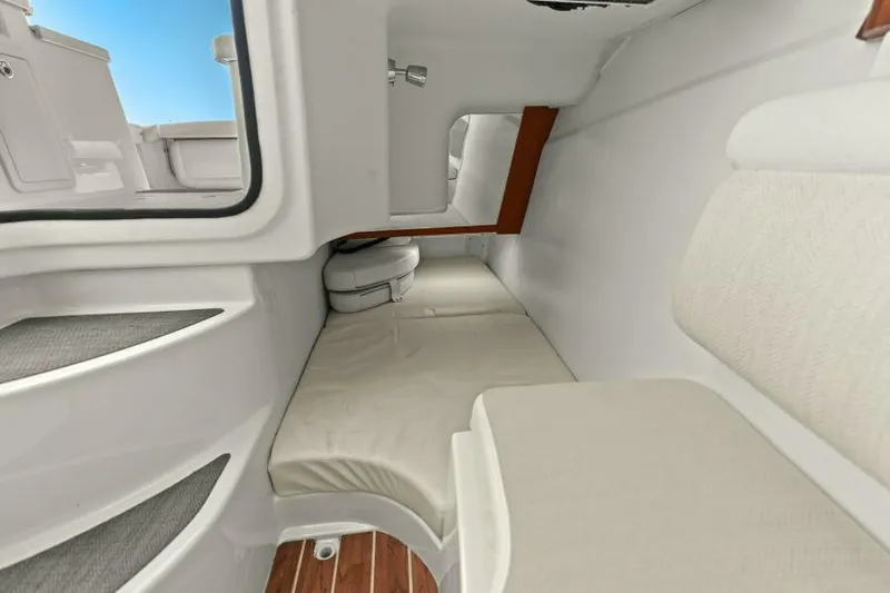  Yacht Photos Pics 2016 Grady-White Freedom 375 cabin interior with cushioned seating and wooden accents.