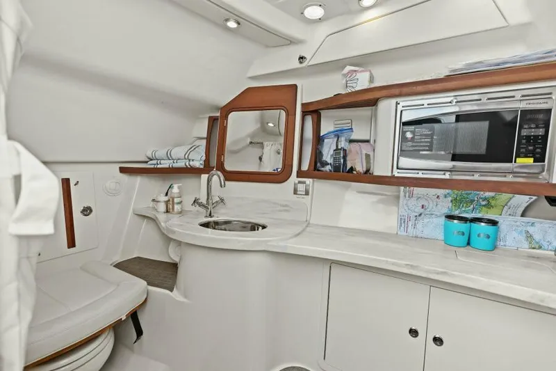  Yacht Photos Pics 2016 Grady-White Freedom 375 cabin interior with kitchenette, sink, and storage.
